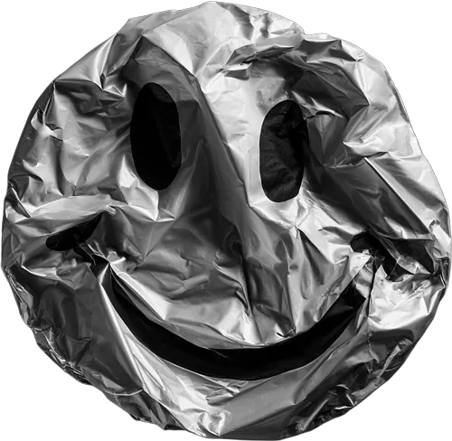 Crinkled metallic foil shaped like a smiley face with eyes and a smile.